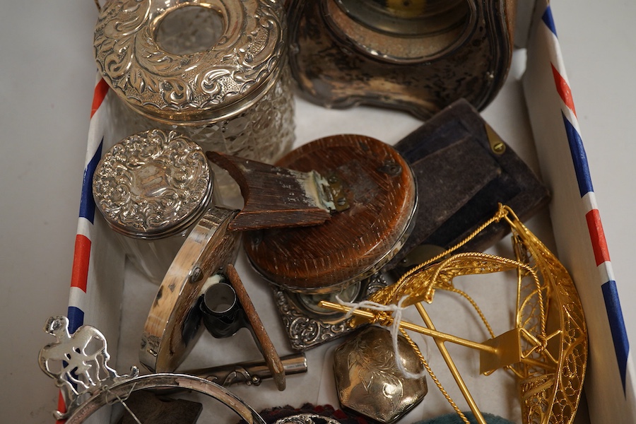 A collection of sundry silver items to include a silver mounted timepiece, hexagonal pill box and photo frames, one housing a hand painted porcelain portrait plaque, largest 12cm high
